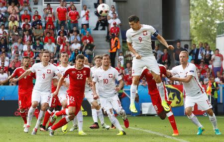 Football Soccer - Switzerland v Poland - EURO 2016 - Round of 16 - Stade Geoffroy-Guichard, Saint-?tienne, France - 25/6/16 Poland's Robert Lewandowski heads clear REUTERS/Yves Herman Livepic