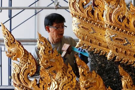 Thai officials from the Conservation Science Division of the Fine Arts Department of the National Museum of Thailand repairs the Royal Chariot, which will be used during the late King Bhumibol Adulyadej's funeral later this year, Thailand, February 6, 2017. Picture Taken February 6, 2017. REUTERS/Chaiwat Subprasom