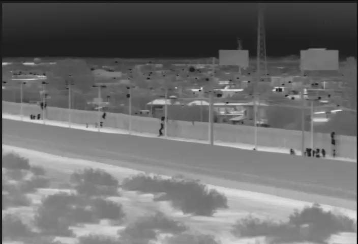 This image from video provided by the Yuma Sector Border Patrol shows a large group of Central American migrants being dropped over the U.S.-Mexico border wall east of the San Luis Port of Entry in Yuma, Arizona, on Friday, Oct. 19, 2018. (Yuma Sector Border Patrol via AP)