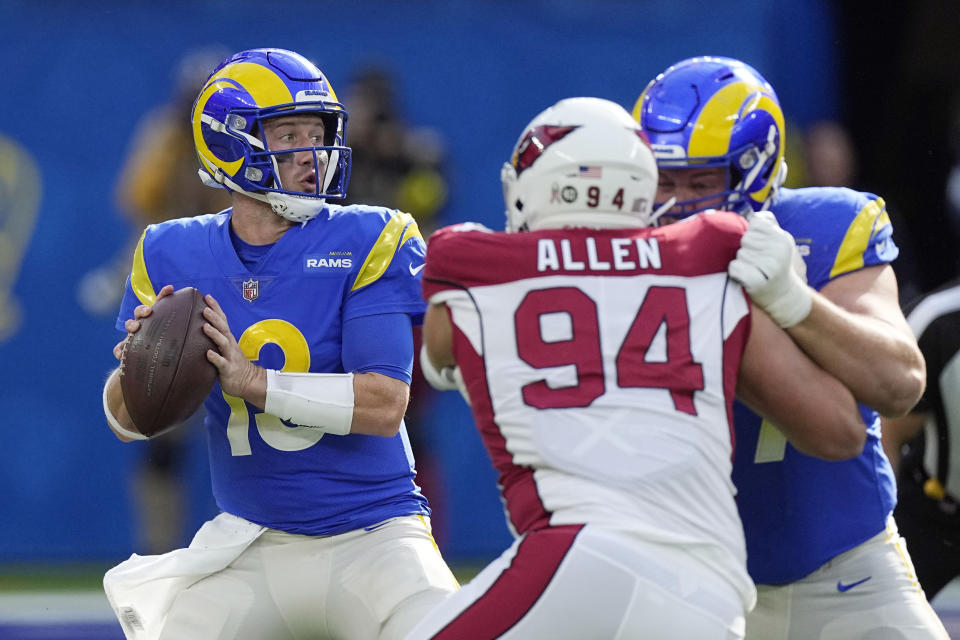 Los Angeles Rams quarterback John Wolford, left, prepares to throw during the first half of an NFL football game against the Arizona Cardinals Sunday, Nov. 13, 2022, in Inglewood, Calif. (AP Photo/Mark J. Terrill)