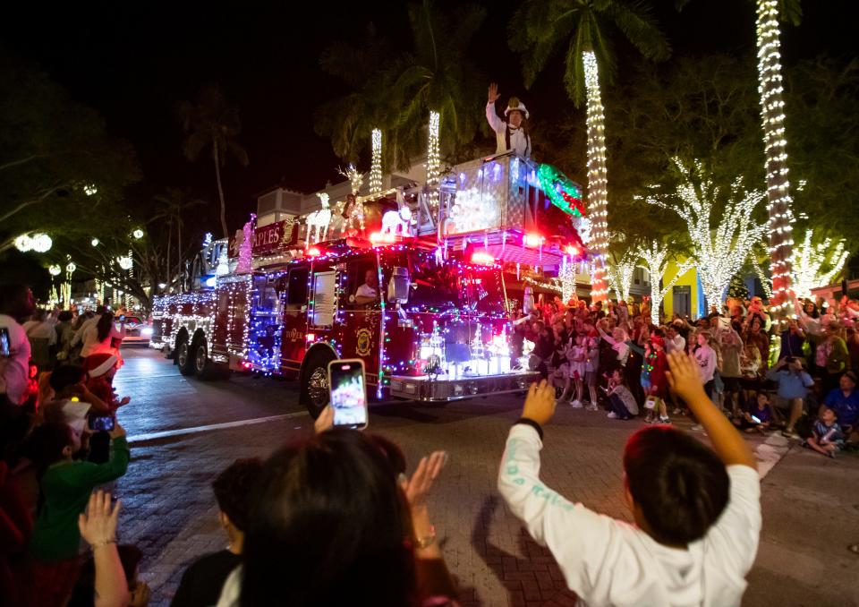 City of Naples Fire Chief Phillip Pennington waves to spectators during the Fifth Avenue South Christmas parade in Naples on Tuesday, Dec. 5, 2023.