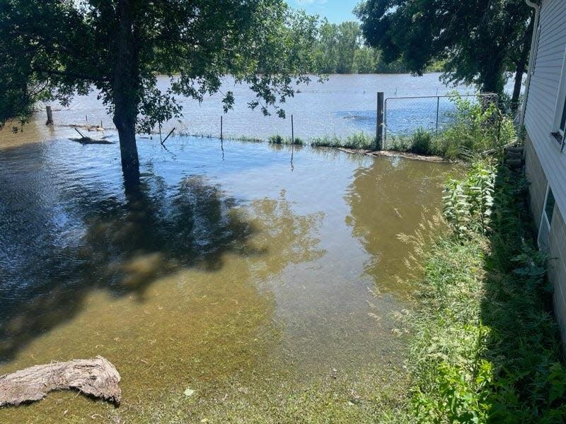 Rapid flooding from Vermillion River forces Chelsey Green, Ross Loebs and their two dogs Asha and Juneau to evacuate their home.