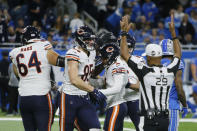 Chicago Bears kicker Cairo Santos is surrounded by teammates after kicking the game winning field goal with time expiring during the second half of an NFL football game against the Detroit Lions, Thursday, Nov. 25, 2021, in Detroit. (AP Photo/Duane Burleson)
