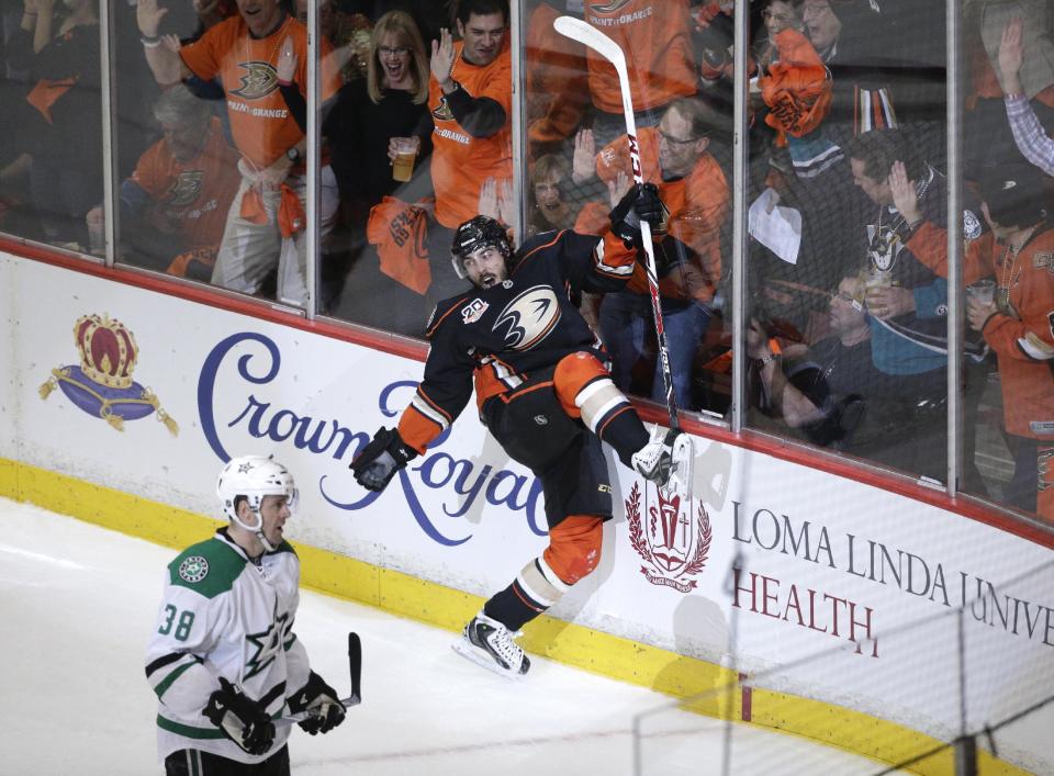 Anaheim Ducks' Mathieu Perreault, center, celebrates his goal near Dallas Stars' Vernon Fiddler during the first period in Game 1 of the first-round NHL hockey Stanley Cup playoff series on Wednesday, April 16, 2014, in Anaheim, Calif. (AP Photo/Jae C. Hong)