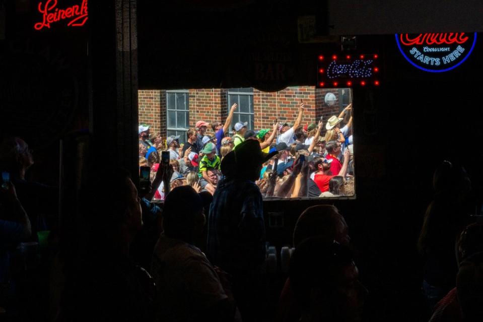 Supporters cheer as Republican presidential candidate and former President Donald Trump arrives for a rally at the Steer N' Stein bar at the Iowa State Fair on Aug. 12.<span class="copyright">Brandon Bell—Getty Images</span>