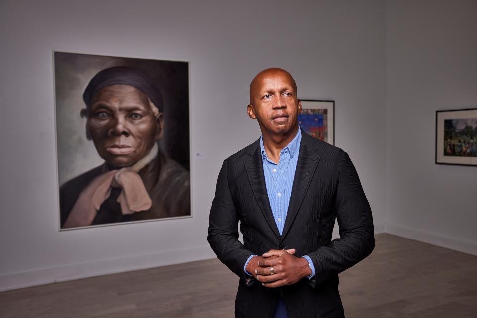 EJI executive director Bryan Stevenson stands in front of a portrait of famed abolitionist Harriet Tubman that hangs inside the Legacy Museum's art gallery.