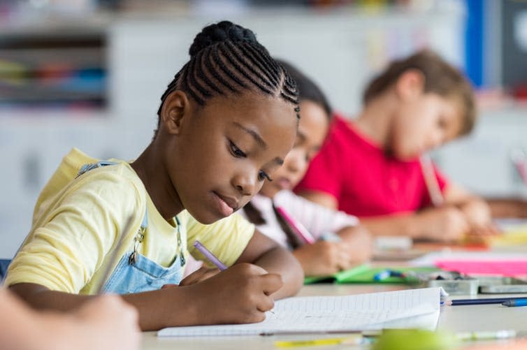 <span class="caption">Teacher assessment is partly based on low-stakes, frequent testing.</span> <span class="attribution"><a class="link " href="https://www.shutterstock.com/image-photo/cute-pupil-writing-desk-classroom-elementary-1288136623" rel="nofollow noopener" target="_blank" data-ylk="slk:Rido/Shutterstock;elm:context_link;itc:0;sec:content-canvas">Rido/Shutterstock</a></span>