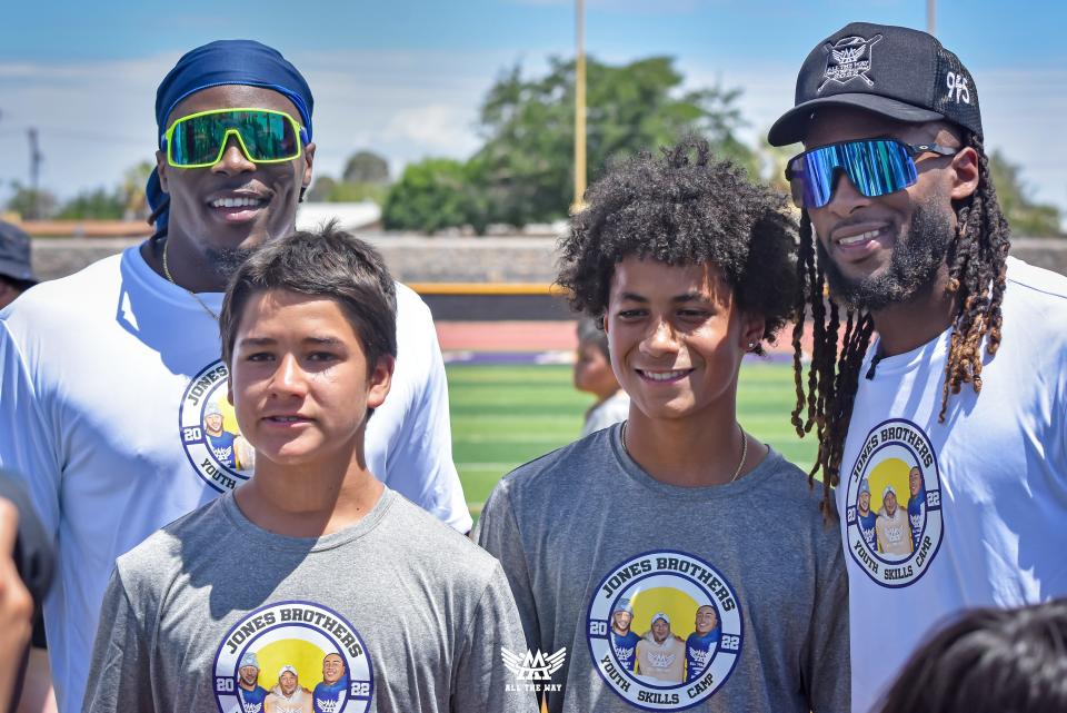 Green Bay Packers running back Aaron Jones, right, and his brother Alvin Jones Jr. pose with participants at the fifth annual Jones Brothers Youth Skills Camp on June 25 at Burges High School in El Paso.