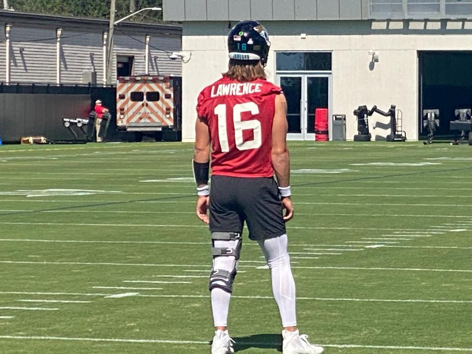 Jacksonville Jaguars quarterback Trevor Lawrence (16) participates in warm-up drills prior to Tuesday, Oct. 17, 2023 practice. Lawrence is sporting a brace on his left leg due to a knee injury.