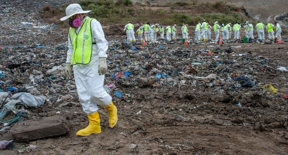 Police searching the landfill for human remains.