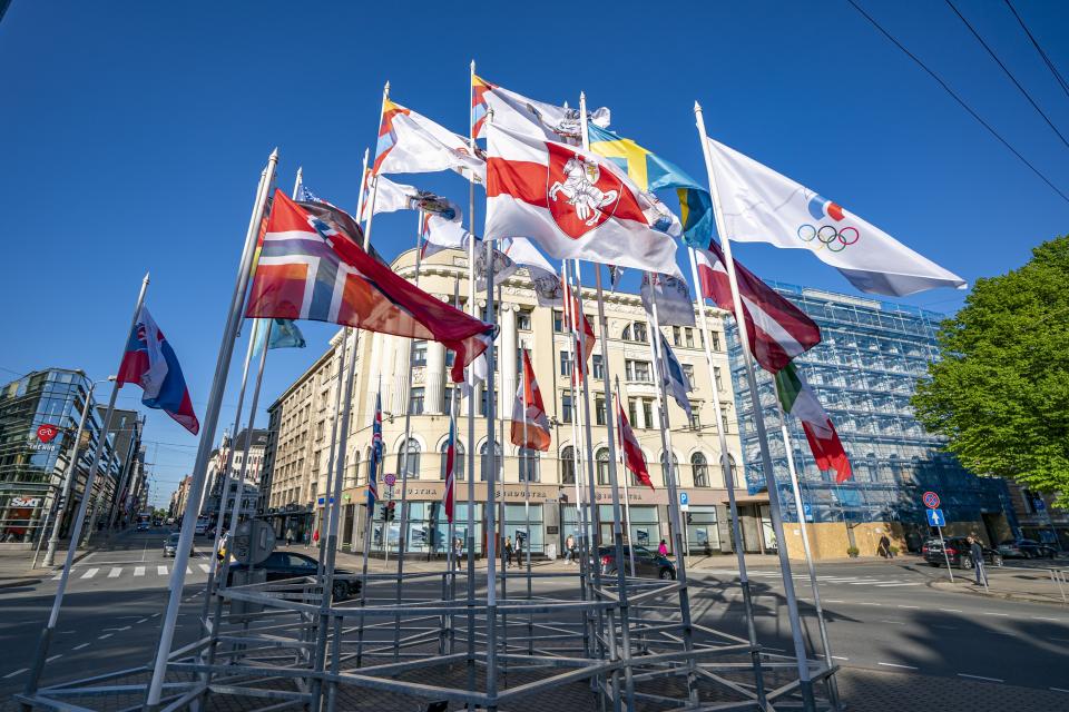 A white-red-white flag, center, the emblem of Belarus' opposition, flies outside the hotel where the Belarusian hockey team is staying for the Ice Hockey World Championship in Riga, Latvia, Monday, May 24, 2021. The Belarusian Foreign Ministry ordered all Latvian diplomats out of the country after the Belarusian flag was replaced Monday with the white-red-and-white one used by the opposition at the world ice hockey championship in Riga, Latvia. (Martins Zilgalvis/F64 Agency via AP)