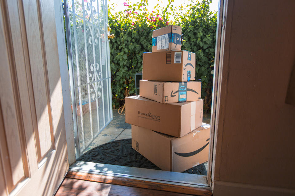 Los Angeles CA, November 11/22/2017: Image of an Amazon packages. Amazon is an online company and is the largest retailer in the world. Cardboard package delivery at front door during the holiday season. shipping package parcel box on wooden floor with protection paper inside. Amazon.com went online in 1995 and is now the largest online retailer in the world.