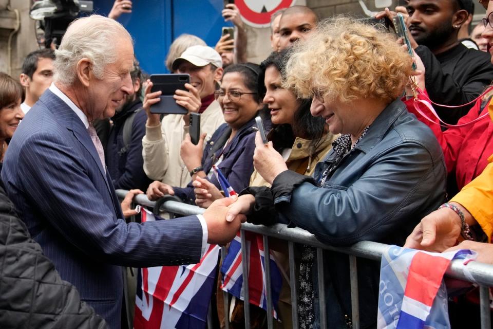 King Charles meets residents after visiting the flower market (AP)