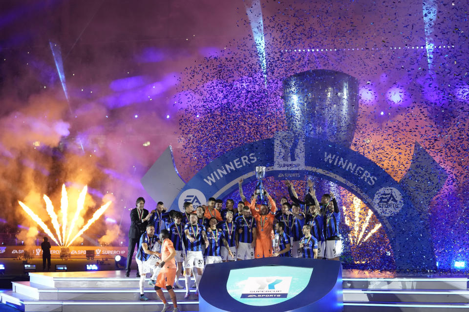 Inter Milan's goalkeeper Samir Handanovic holds the trophy as he celebrates with his teammates after winning the Italian Super Cup final soccer match between AC Milan and Inter Milan at the King Saud University Stadium, in Riyadh, Saudi Arabia, Wednesday, Jan. 18, 2023. Inter Milan won 3-0. (AP Photo/Hussein Malla)