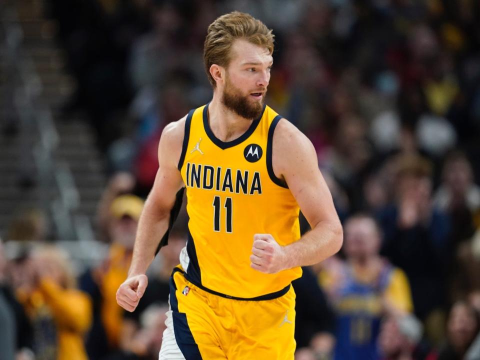 Domantas Sabonis pumps his fist while running down the court.