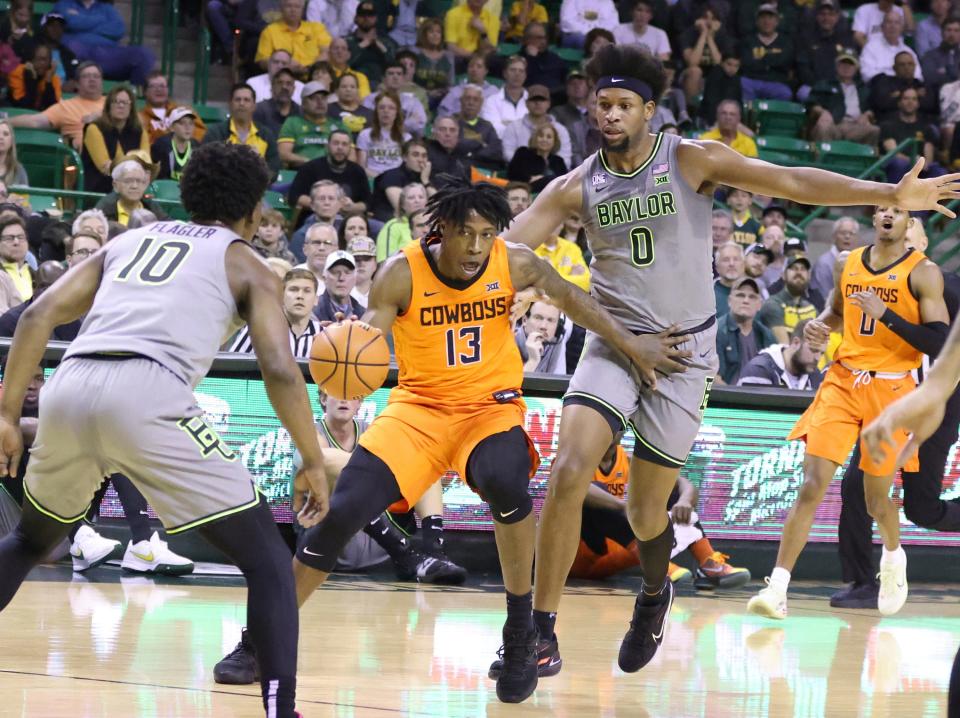 Oklahoma State guard Quion Williams (13) is defended by Baylor guard Adam Flagler (10) and forward Jalen Bridges (11) in the first half of an NCAA college basketball game, Saturday, Jan. 14, 2023, in Waco, Texas. (Rod Aydelotte/Waco Tribune-Herald, via AP)