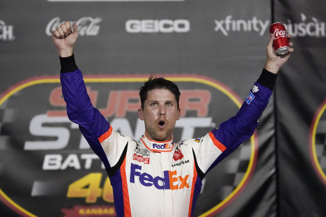 Denny Hamlin celebrates after winning a NASCAR Cup Series auto race at Kansas Speedway in Kansas City, Kan., Thursday, July 23, 2020. (AP Photo/Charlie Riedel)