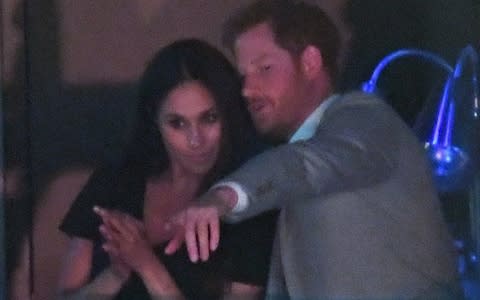 Prince Harry left his seat to join Meghan Markle - Credit: Wireimage