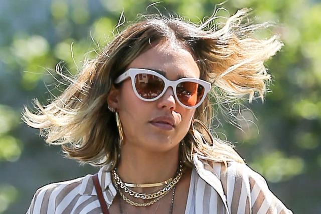 Jessica Alba in striped shirt, white trousers and brown leather