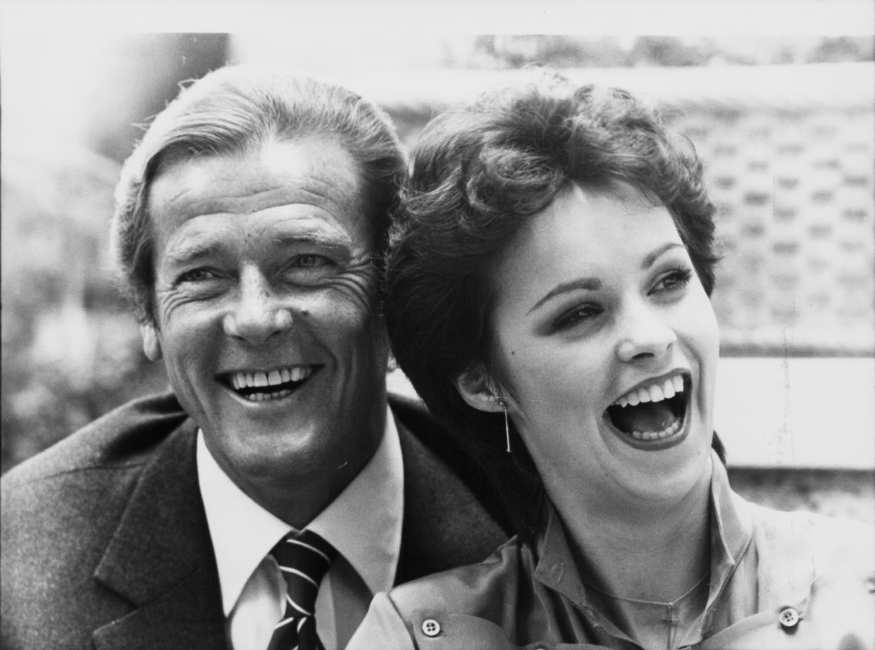 Actor Roger Moore and singer Sheena Easton posing together, to promote the film 'For Your Eyes Only', and the song of the same name, 1981. (Photo by Express/Archive Photos/Getty Images)