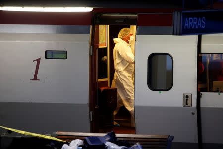 French investigating police in protective clothing collect clues inside the Thalys high-speed train where shots were fired in Arras, France, August 21, 2015. REUTERS/Pascal Rossignol
