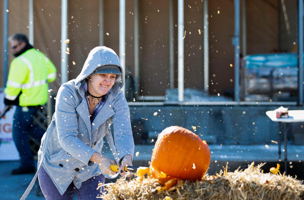 Heather Summers smashes a pumpkin with a sledgehammer during the Springfield Yardwaste Recycling Center's first pumpkin smash on Saturday, Nov. 2, 2019.