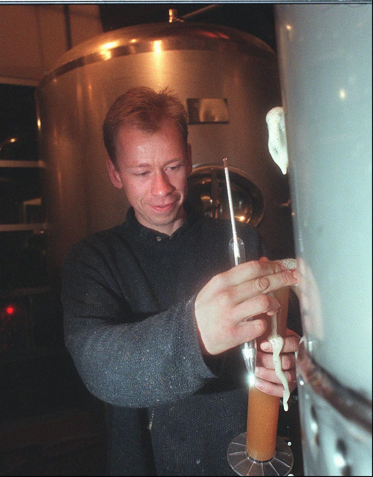 Brewmaster Dave Hartmann checks the gravity level in the Empire Brewing Company's Hefe-Weizen Yeast Wheat beer in the brewing room in January 1997.