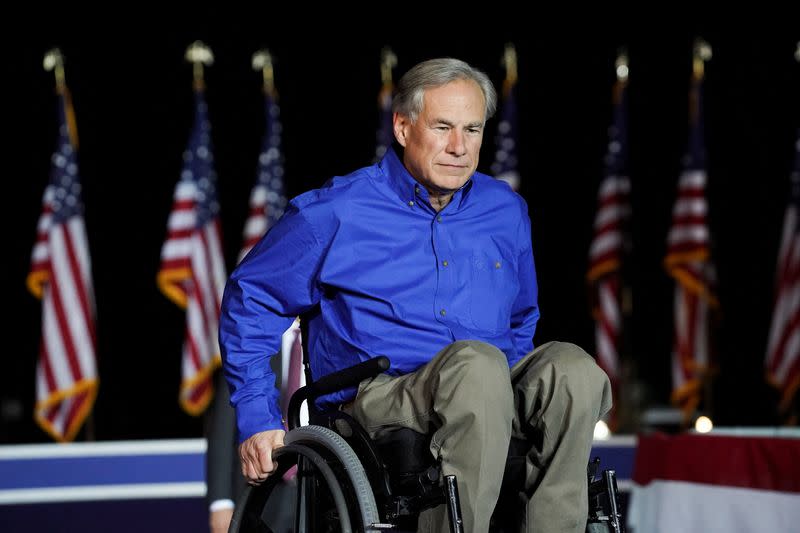 FILE PHOTO: Texas Governor Greg Abbott attends former U.S. President Donald Trump's rally in Conroe