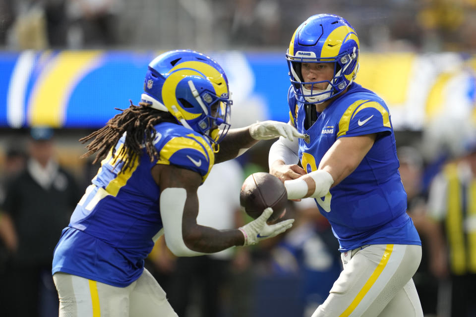 Los Angeles Rams quarterback Matthew Stafford (9) hands off to Rams running back Darrell Henderson (27) during the second half of an NFL football game against the Pittsburgh Steelers Sunday, Oct. 22, 2023, in Inglewood, Calif. (AP Photo/Ashley Landis)