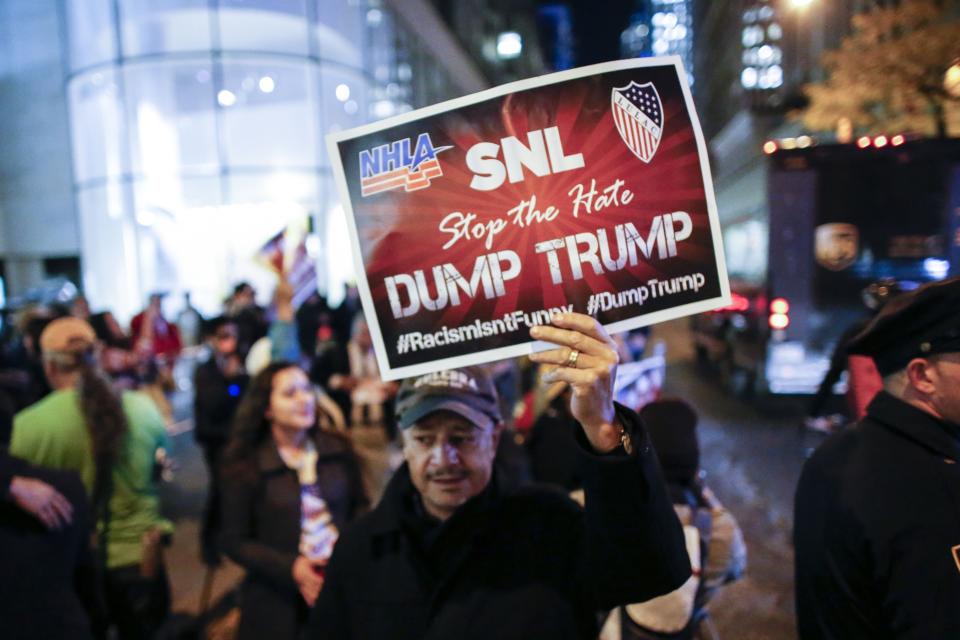 People protest in  front of NBC studios while they are calling for the network to rescind the invitation to Donald Trump to host Saturday Night Live show on November 4, 2015 in New York. 