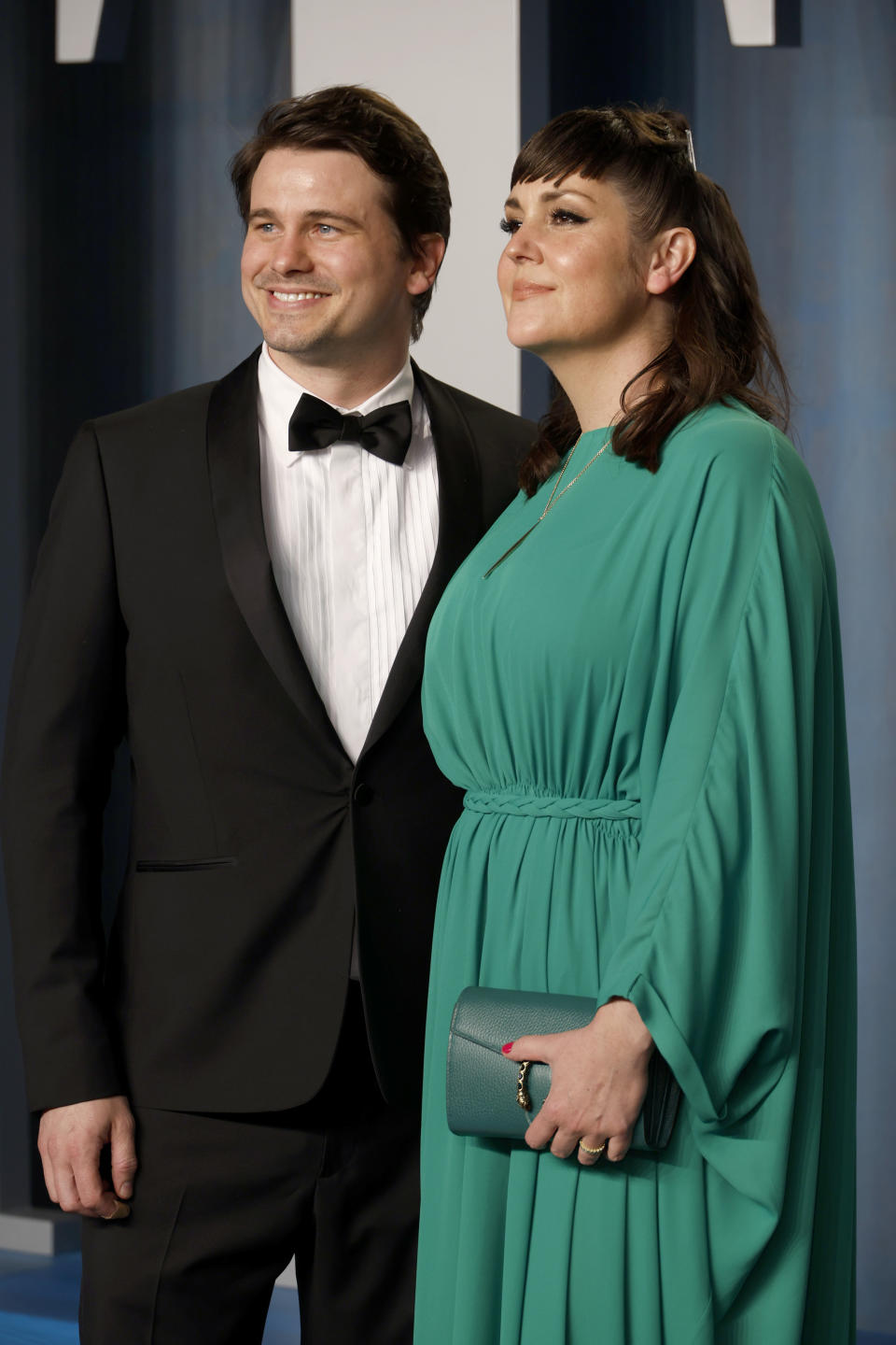 Smiling Jason in a bow tie and smiling Melanie in a long-sleeved dress