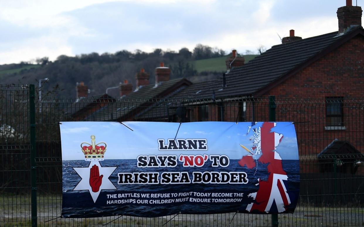 A sign is seen with a message against the Brexit border checks in relation to the Northern Ireland protocol in Larne