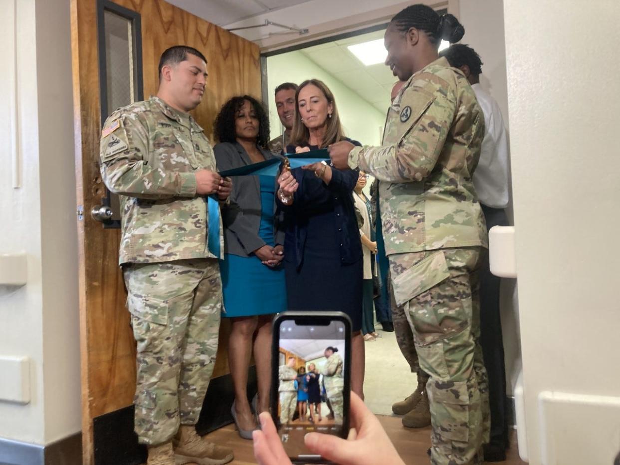 Kimberly Green, director of Fort Bragg's new Sexual Harassment/Sexual Assault Fusion Directorate office, cuts the ribbon to the space in Fort Bragg's Soldier Support Center on Thursday, April 28, 2022.