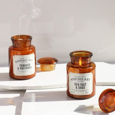 A tobacco and patchouli candle in an amber apothecary jar that's waaay too pretty to be this price