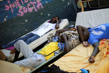 Migrants rest at a makeshift camp in Via Cupa (Gloomy Street) in downtown Rome, Italy, August 1, 2016. REUTERS/Max Rossi