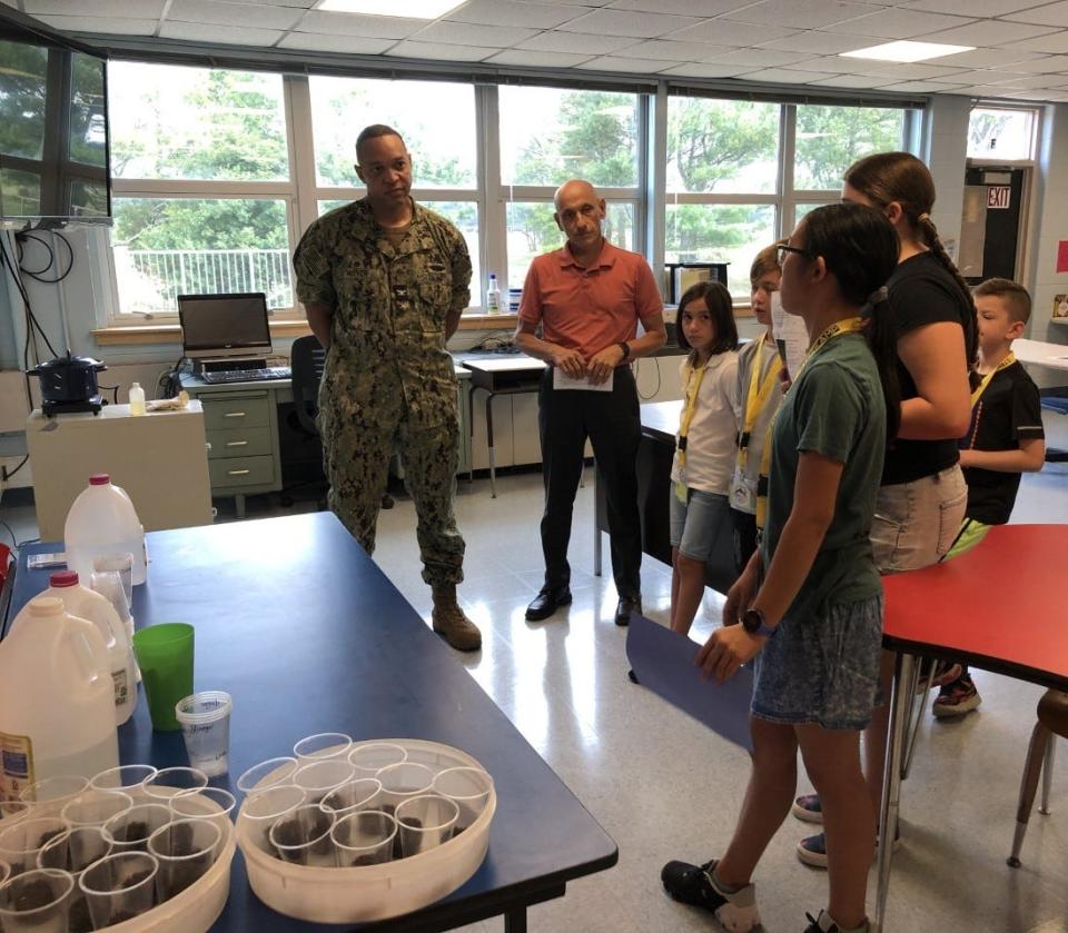 Capt. James McIver of Naval Station Newport and Sen. Louis DiPalma listen to a presentation during Middletown's STEM Kamp on Friday, Aug. 5, 2022.