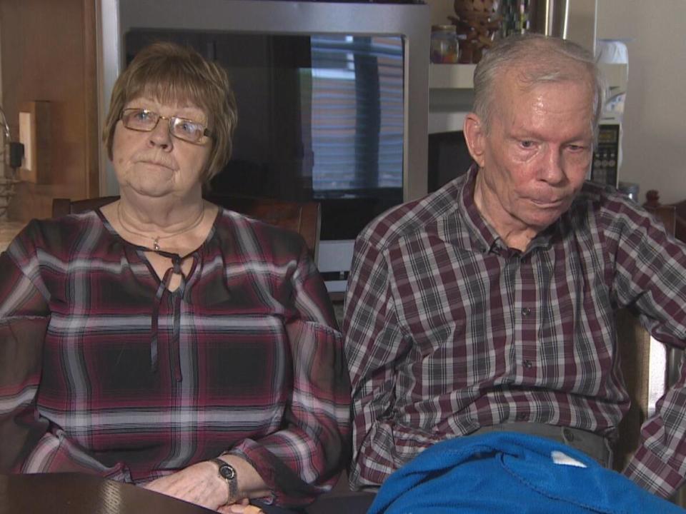 Juanita Hull, left, and Gordon Hull sit for an interview in their home in Springdale in late 2019. The couple left Little Bay Islands in 2016 to bring Gordon, who had a stroke in 2003, closer to health-care services. (Sherry Vivian/CBC - image credit)