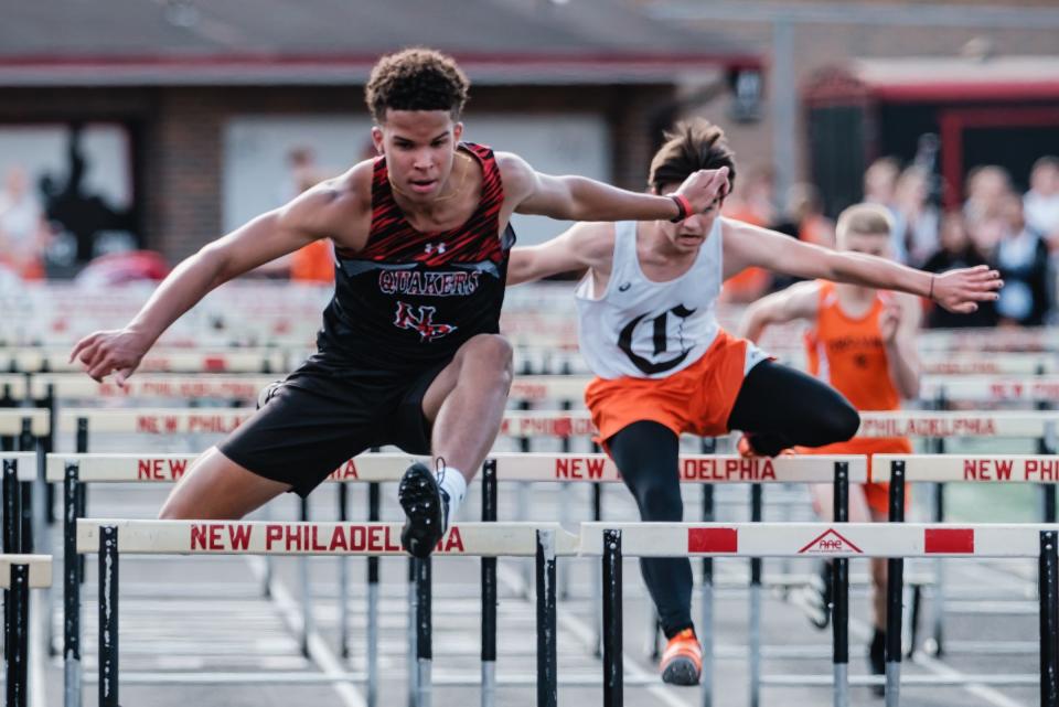 New Phila's O'Rhen Martin competes in the 110 meter hurdles during the Tuscarawas County Classic Monday at Woody Hayes Quaker Stadium in New Philadelphia.