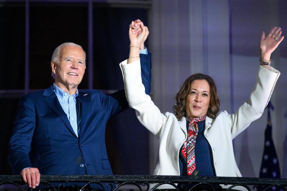 President Joe Biden and Vice President Kamala Harris raise their arms as guests cheer after watching the Independence Day fireworks from the White House in Washington, D.C., on July 4, 2024. (Mandel Ngan/AFP/Getty Images/TNS)