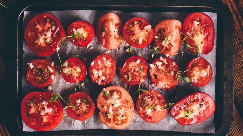 Halved tomatoes on baking sheet