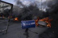 Palestinian protesters block the main road with burning tires in the West Bank city of Jericho, Monday, Feb. 6, 2023. Israeli forces killed five Palestinian gunmen in a raid on refugee camp in the occupied West Bank on Monday, the latest bloodshed in the region that will likely further exacerbate tensions. (AP Photo/Nasser Nasser)