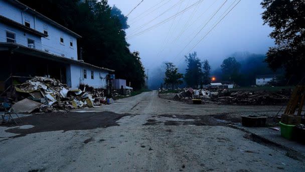 PHOTO: Piles of debris and a mud cover road are seen after massive flooding, Aug. 5, 2022, in Lost Creek, Ky. (Brynn Anderson/AP)