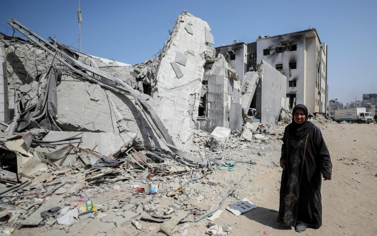 A woman near the damaged Al-Shifa hospital after Israeli forces withdrew following a two-week operation