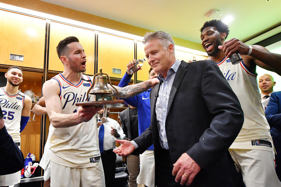 JJ Redick hands the 76ers’ celebratory liberty bell back to head coach Brett Brown after their Game 5 victory over the Miami Heat. (Getty)