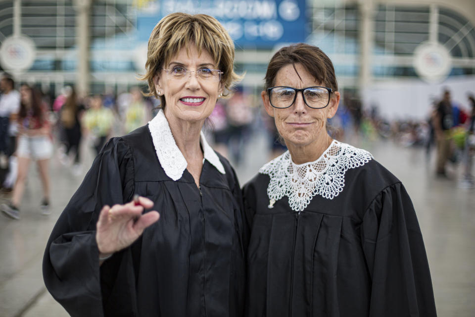 Cosplayers Terri Crinnion as Judge Judy (L) and Lorri Wilke as Supreme Court Justice Ruth Bader Ginsburg.