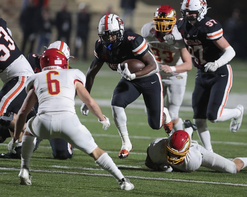 Massillon's Nolan Davenport (97) watches teammate Willtrell Hartson run through a hole vs. Big Walnut in a playoff game, Nov. 11, 2022.