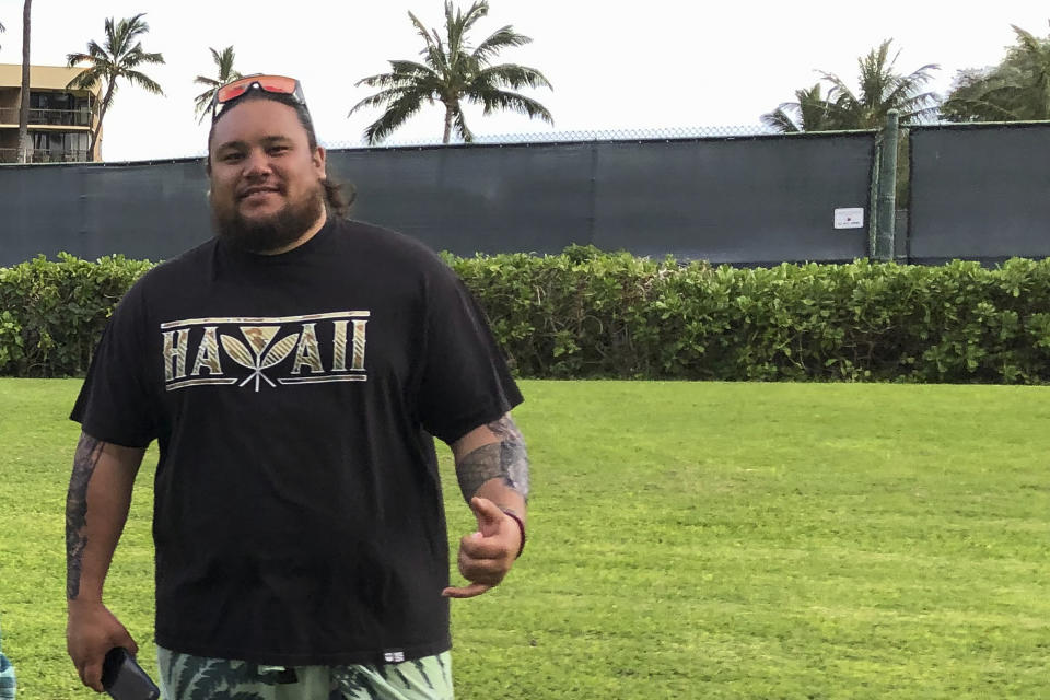 In this photo provided by Kapu'uwaikahiau Schildmeyer, Levi Aki Jr. stands at Maui Sunset Beach Park in Kihei, Maui, Hawaii, on April 15, 2022. Aki is one of two Native Hawaiian men facing sentencing on Thursday, March 2, 2023, after a jury convicted them of a hate crime for a 2014 beating of a white man who tried to move into their remote, traditional village. (Kapu'uwaikahiau Schildmeyer via AP)