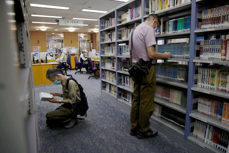 People read books at Hong Kong Central Library after democracy activists' books were taken down due to national security law in Hong Kong