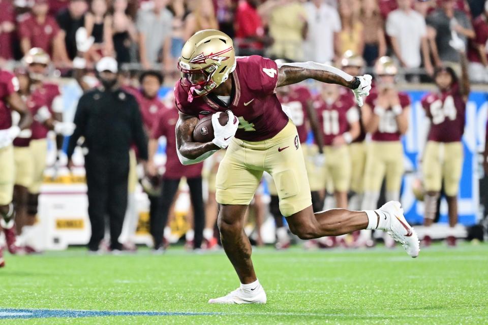 Keon Coleman of the Florida State Seminoles catches a 40-yard touchdown pass in the first quarter against the LSU Tigers.