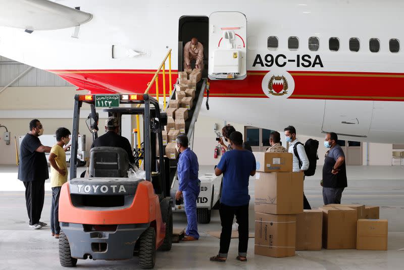 Bahraini officials load medical aid and ground-support equipment into a plane to support Lebanon